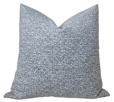 Indigo blue Sarong Weave Pillow Cover with ivory backing displayed on a chair