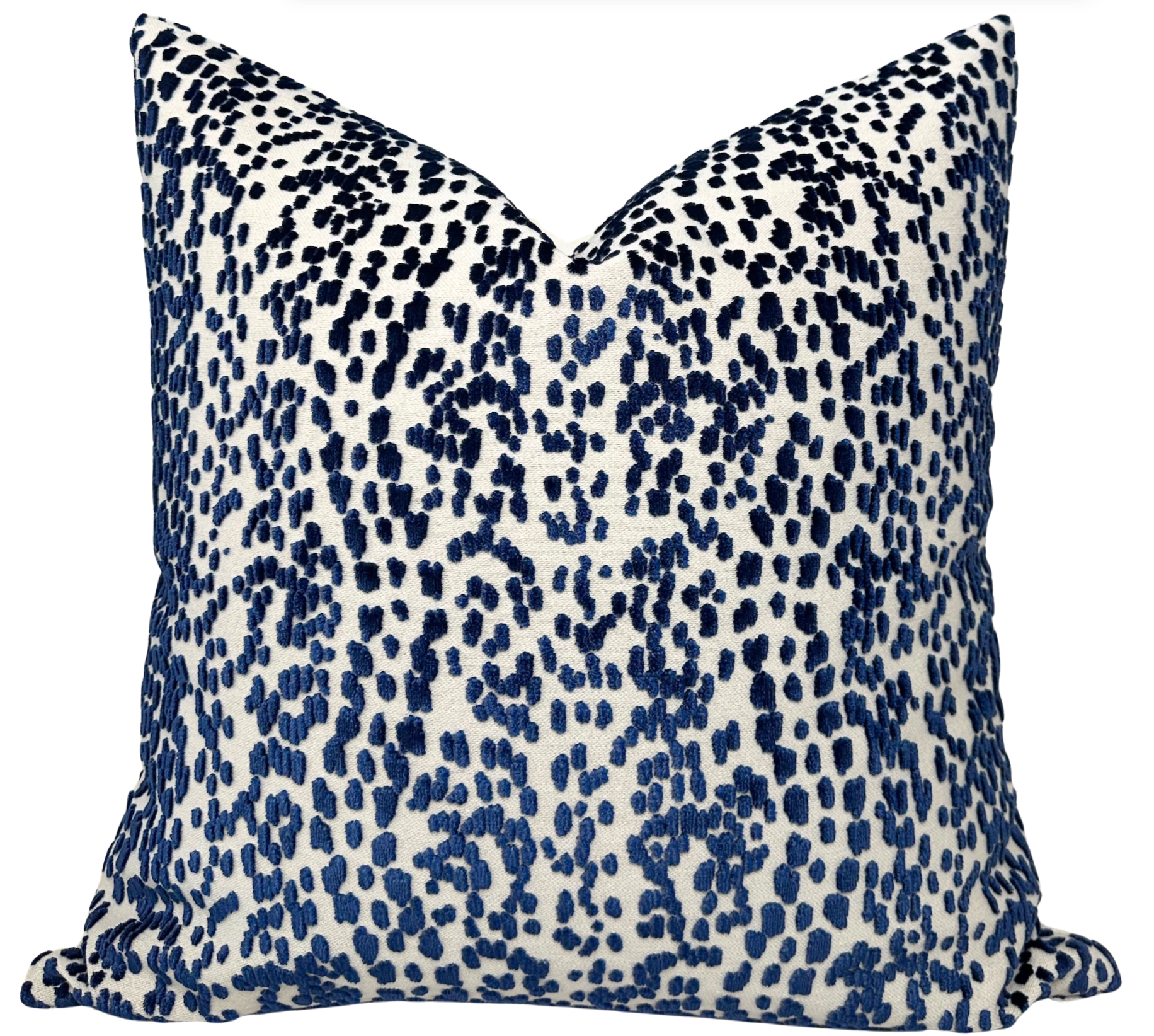 Blue velvet pillow cover with ivory linen back on a sofa