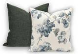 Pair of square pillows, one solid dark green textured fabric, the other white with slate-blue hydrangea floral pattern and greenish leaves