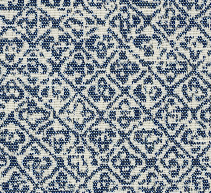 Close-up of indigo blue Sarong Weave textile featuring intricate traditional geometric and floral patterns on a natural cream background.