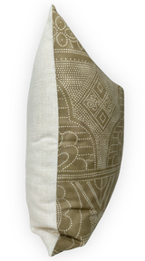 Side view of a pillow with one camel brown patterned fabric panel featuring white dotted geometric designs and a solid off-white fabric panel.