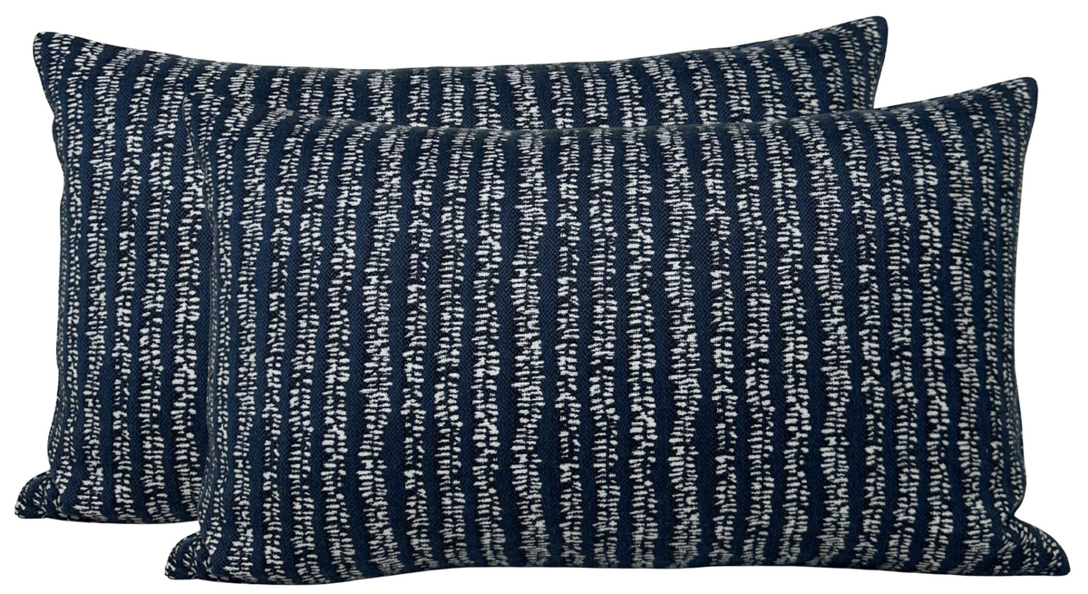 Two rectangular pillow covers in Atlantic Blue with irregular vertical white woven stripes creating a textured, patterned fabric surface.