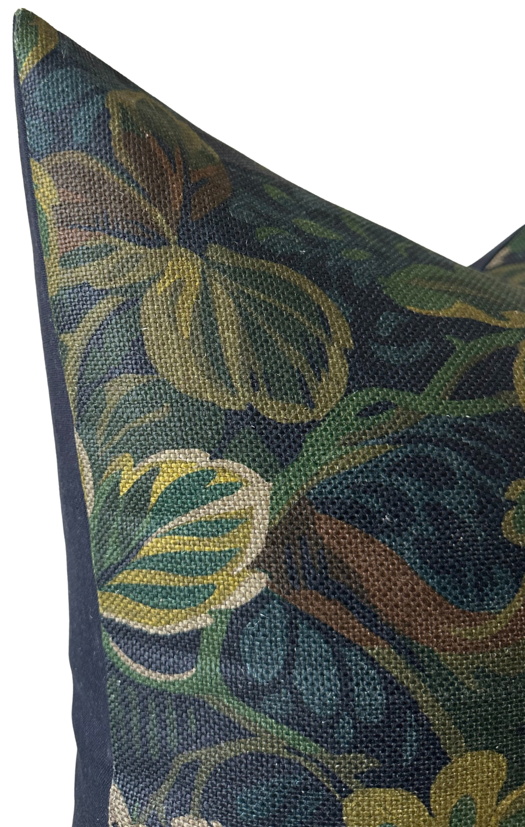 Close-up of a pillow corner with a Midnight Blue Night Garden fabric featuring muted yellow and green floral and leaf patterns on a dark blue background