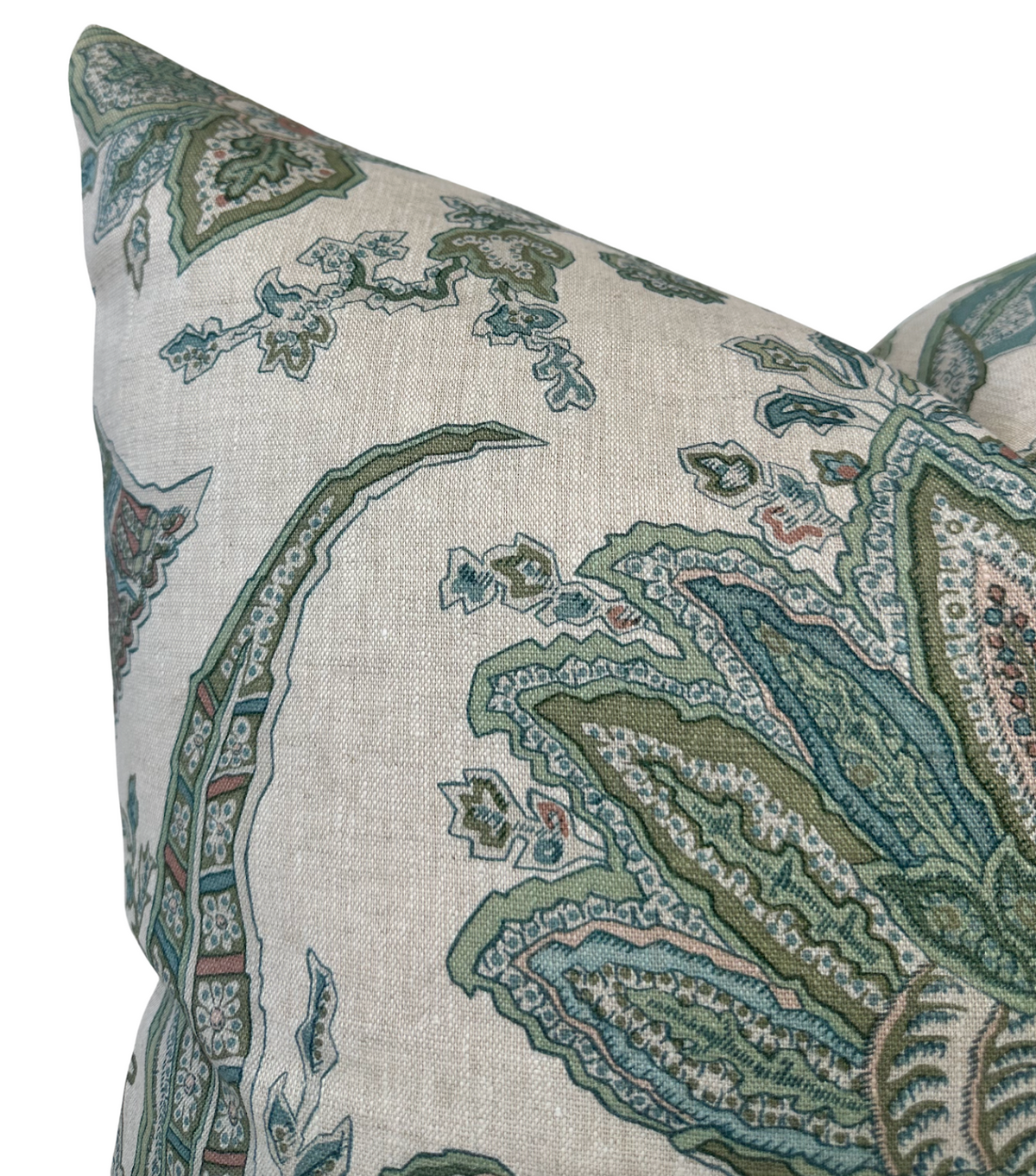 Close-up of a pillow cover with a sage green and blue floral pattern on a light beige background, showing intricate leaf and vine details.