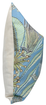 Square pillow with spa blue front featuring botanical pattern of leaves and seed pods in cream, green, and brown, and a plain beige fabric back, shown from a side angle.