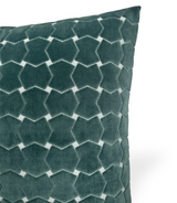Close-up of a seafoam green velvet pillow with a geometric hinge pattern creating a textured, honeycomb-like effect.
