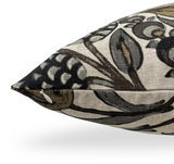 Close-up of a beige pillow cover with intricate gold, grey, and black floral and leaf patterns, featuring a visible hidden zipper along one edge.