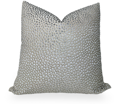 Grey velvet pillow cover with beige linen back folded on a chair