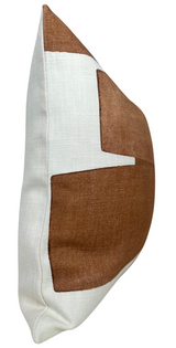 Side view of a square pillow cover with a white base and a clay-colored geometric pattern wrapping around one corner.