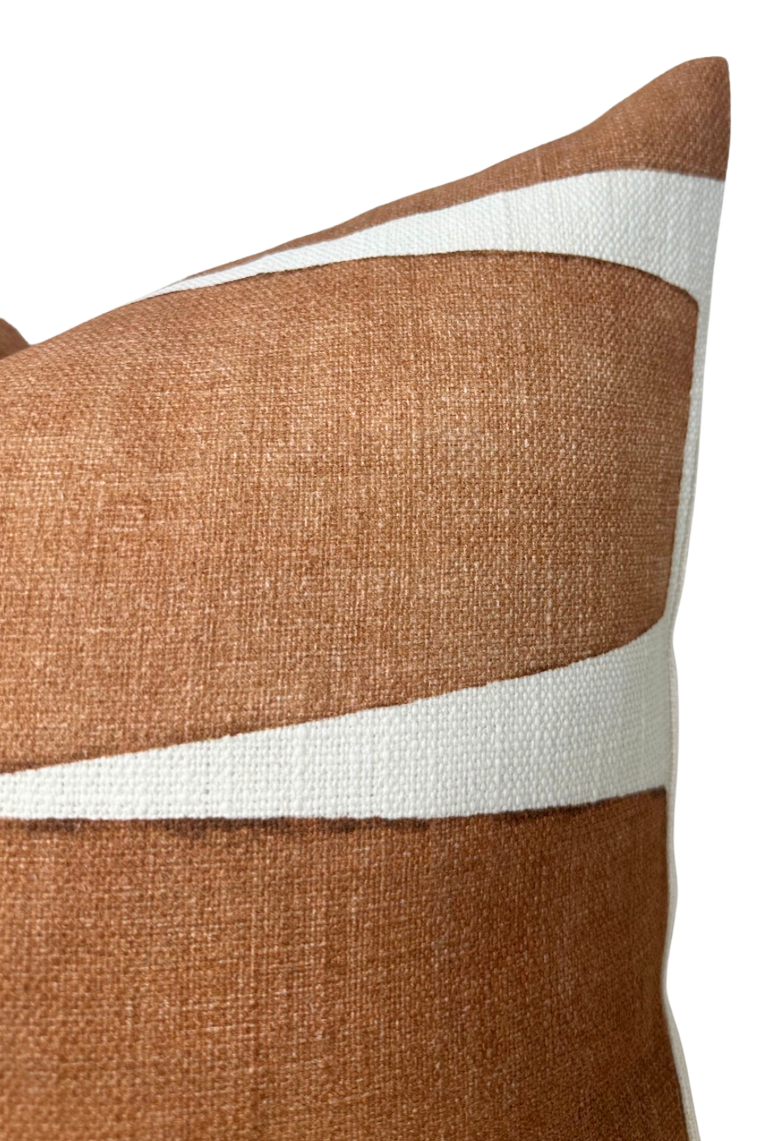 Rectangular pillow cover in terracotta clay fabric with two curved white stripes running diagonally, showing textured woven material in close-up.