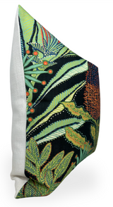 Rectangular pillow with a white textured back and a front featuring green, orange, and black botanical patterns with leafy and berry motifs.
