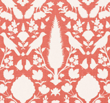White bird and floral silhouettes on coral background in symmetrical, repeating botanical pattern of Chenonceau design by Schumacher Textiles.