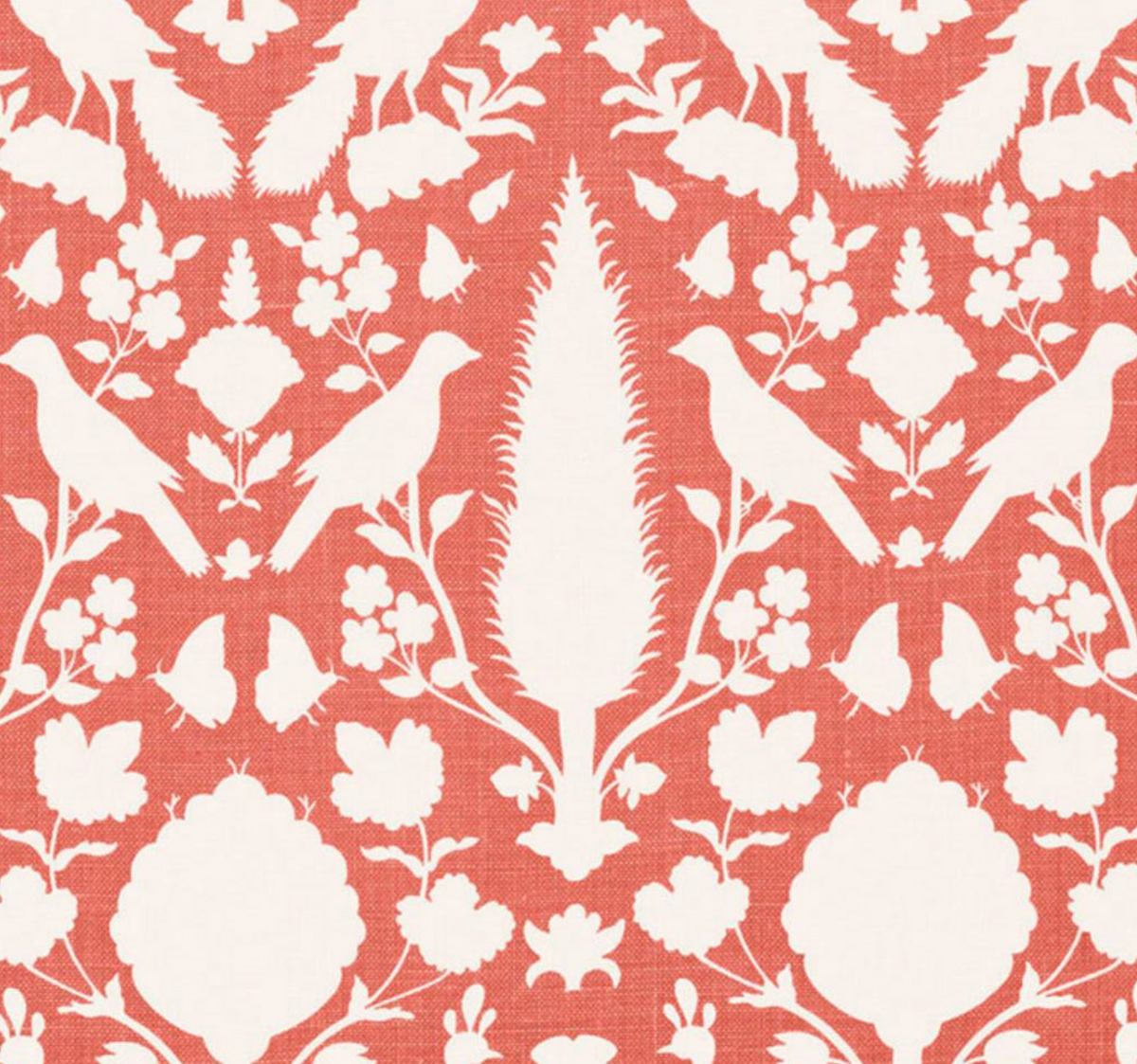 White bird and floral silhouettes on coral background in symmetrical, repeating botanical pattern of Chenonceau design by Schumacher Textiles.