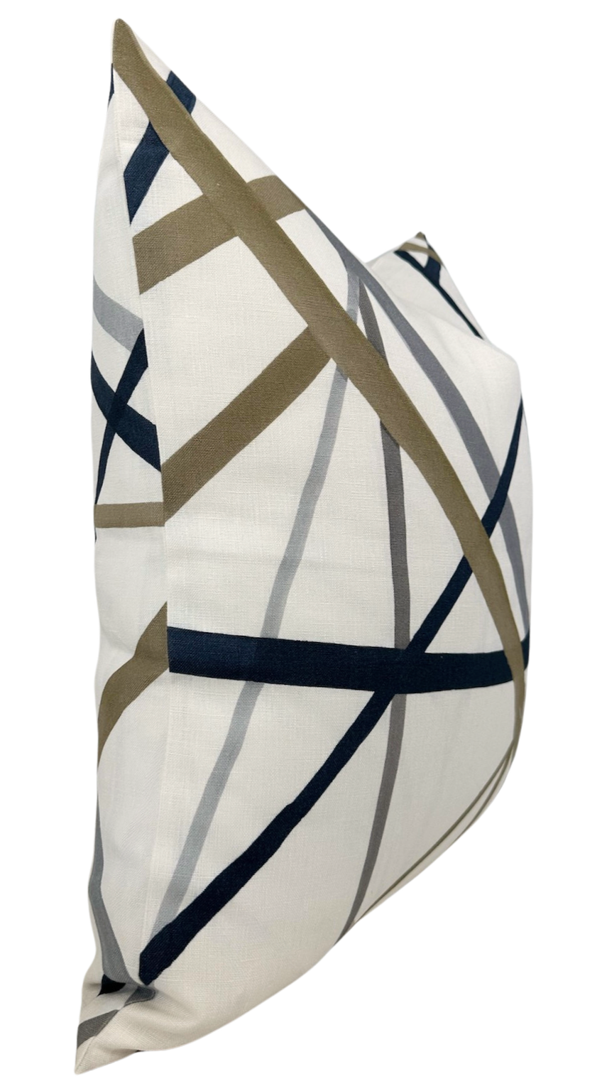 Side view of a square pillow cover with an off-white background featuring intersecting thick navy, taupe, and gray diagonal lines in an abstract pattern.