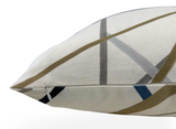 Close-up of a pillow corner with sand-colored fabric featuring intersecting abstract lines in gray, brown, and blue, and a visible side zipper.