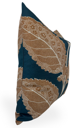 Rectangular pillow with ochre leaf patterns featuring detailed dot and line textures on a mineral blue background, shown from a side angle.