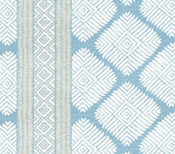 Blue fabric with white diamond-shaped geometric patterns and a vertical stripe featuring beige and white intricate designs.