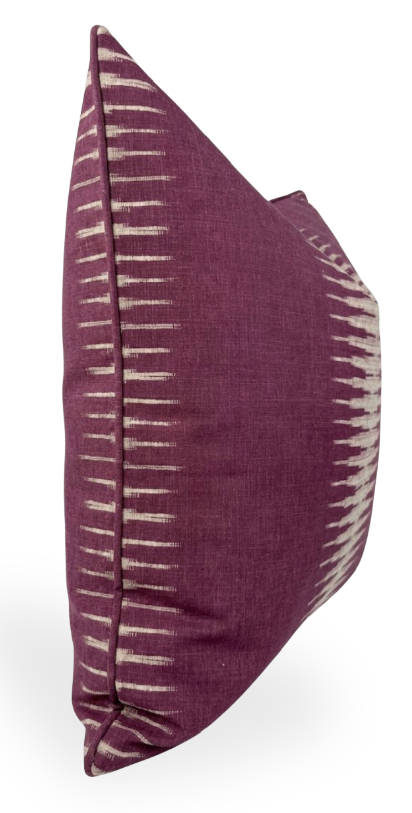 Square pillow cover with deep purple fabric featuring off-white ikat vertical dash patterns along the edges, shown in a side and partial front view.