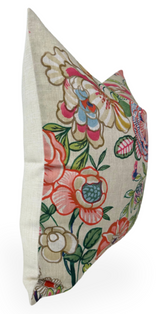Beige pillow cover with a colorful peony floral pattern featuring pink, red, green, and blue hues, shown from a side angle highlighting its square shape.