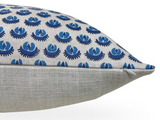 Rectangular pillow with blue floral pattern on off-white fabric upper side and textured light beige fabric on the bottom, shown in side profile with visible zipper.