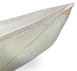 Close-up of a textured pillow cover showing muted brown geometric lines on a light beige fabric with a neatly stitched corner.