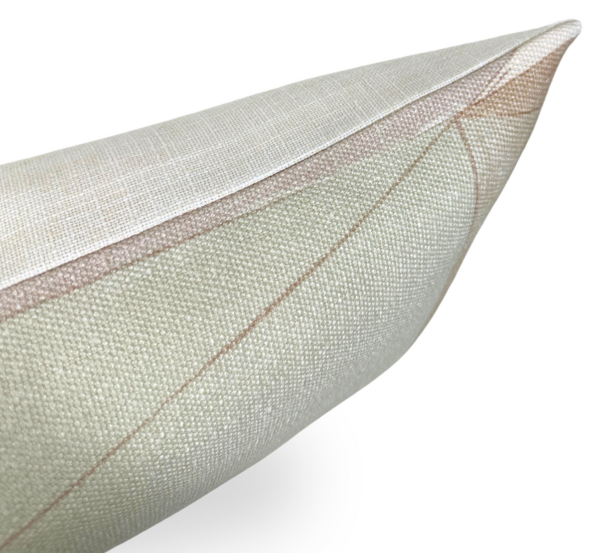 Close-up of a textured pillow cover showing muted brown geometric lines on a light beige fabric with a neatly stitched corner.