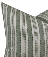 Close-up of a pillow cover with vertical green and natural beige stripes formed by a textured woven pattern.