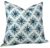 Square pillow cover with repeating dark blue starburst motifs on light blue stepped diamond shapes, set against a white background, displaying a sharp, crisp pattern.