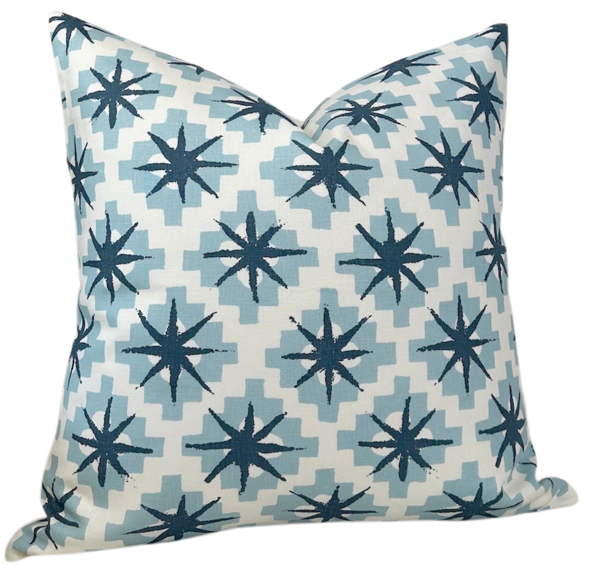 Square pillow cover with repeating dark blue starburst motifs on light blue stepped diamond shapes, set against a white background, displaying a sharp, crisp pattern.