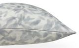 Side view of a pillow with light gray abstract leaf patterns on a white background and a neatly finished edge seam.
