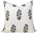 White pillow cover with a repeating pattern of small botanical motifs in indigo and olive green, arranged evenly across the fabric