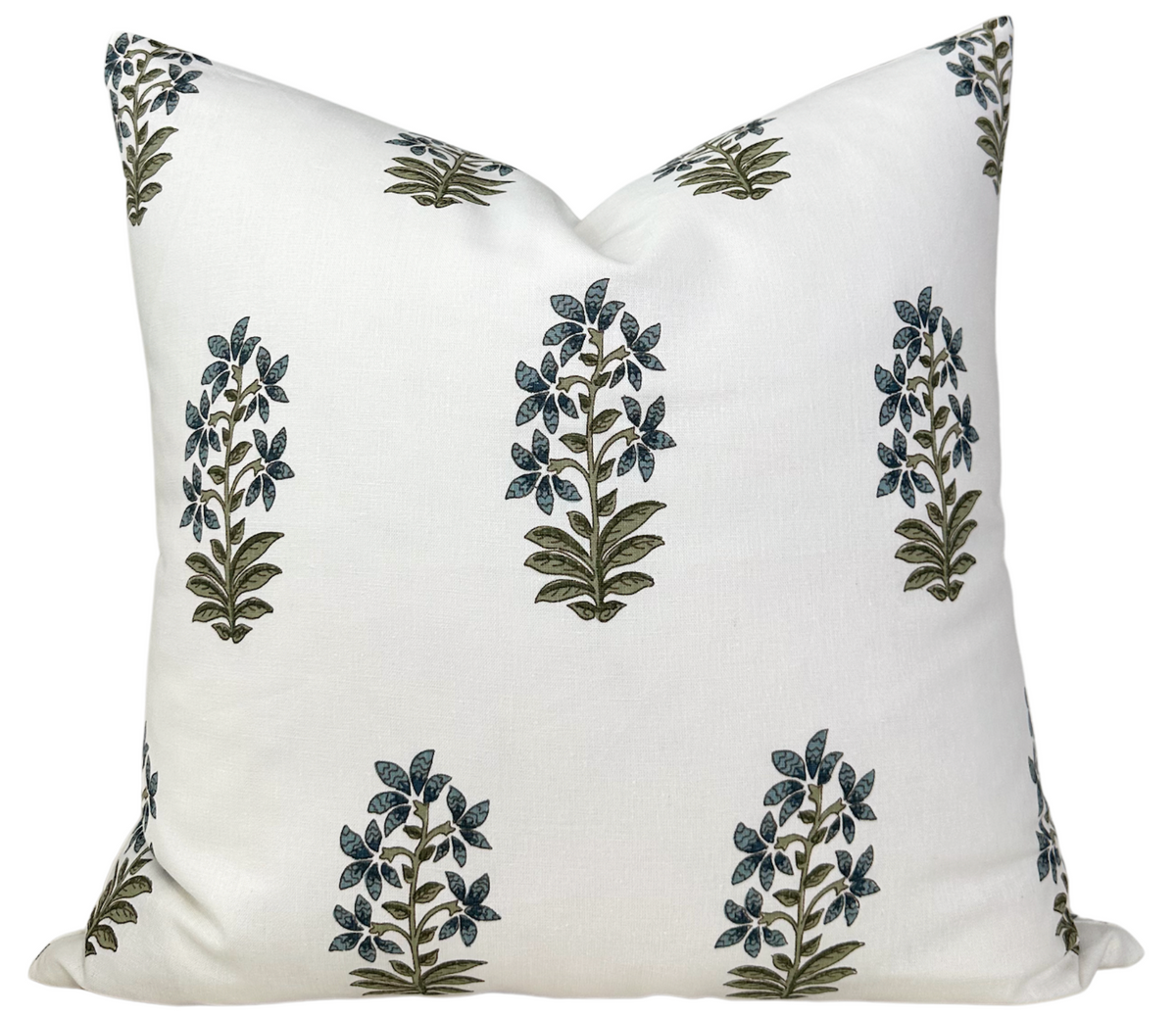 White pillow cover with a repeating pattern of small botanical motifs in indigo and olive green, arranged evenly across the fabric