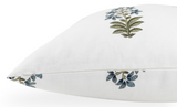 White pillow cover with a minimalist floral pattern featuring green stems and blue leaves, shown in a side profile view.