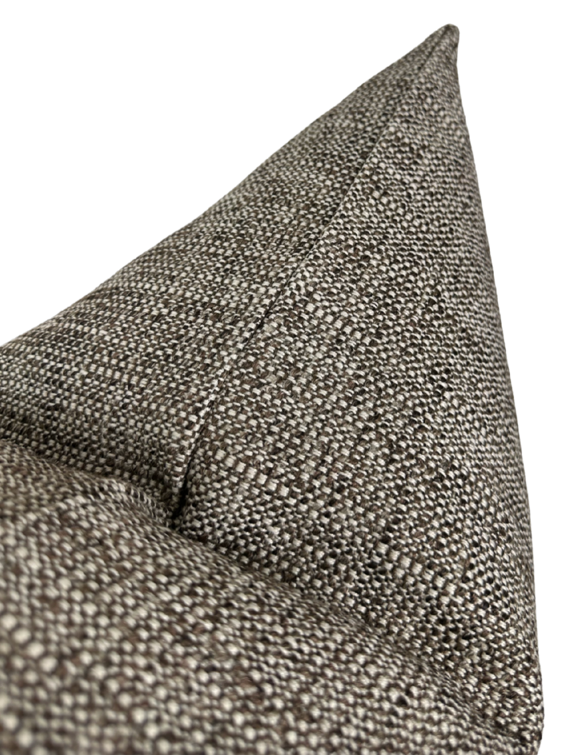 Close-up of a textured pillow cover in chestnut color featuring a tight woven pattern and a sharply pointed corner seam.