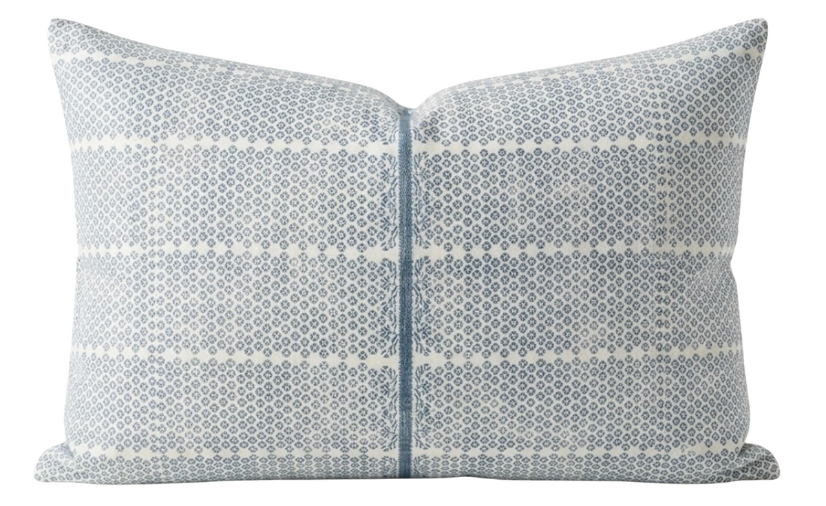 Rectangular pillow cover with light blue and white woven pattern featuring small dots and diamond shapes, centered zip closure with blue trim detailing.