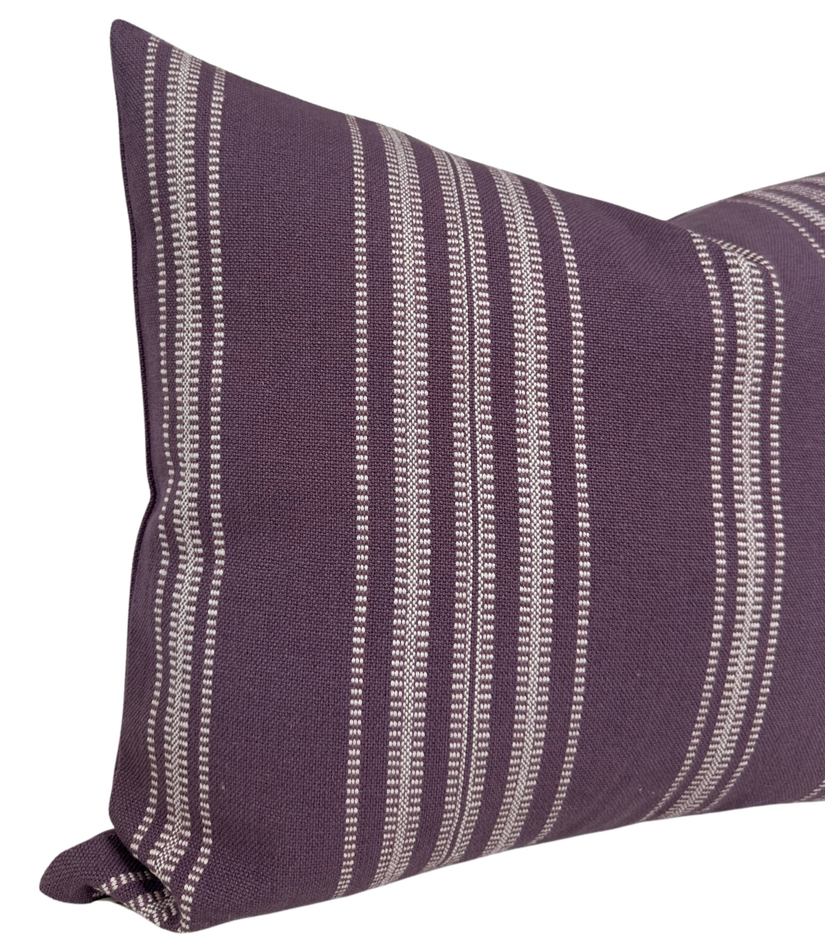 Close-up of a royal purple pillow cover featuring vertical white Mayan-inspired striped patterns on woven fabric.