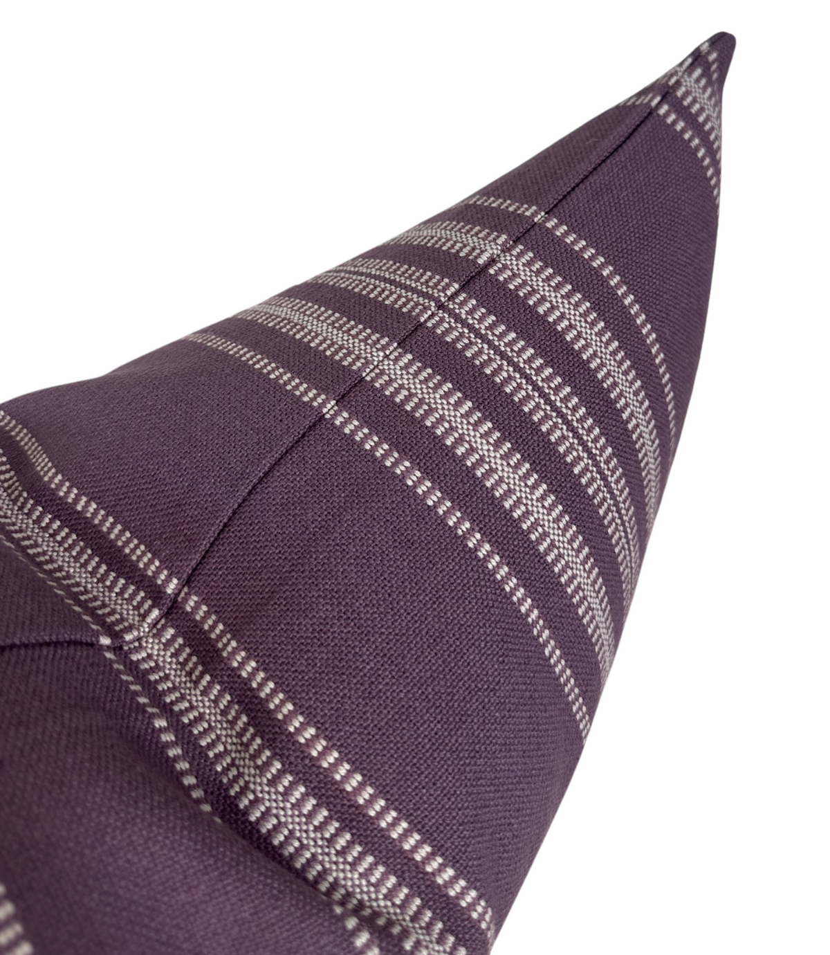 Close-up of a deep purple pillow cover featuring horizontal white Mayan-inspired stripe patterns and a central seam detail.