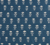 Close-up of Yukka Woven Pillow Cover fabric in Atlantic Blue with small white floral motifs arranged in rows over textured weave.