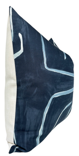 Square pillow with navy blue cover featuring abstract white and light blue linear graffiti patterns and a plain light beige back panel.
