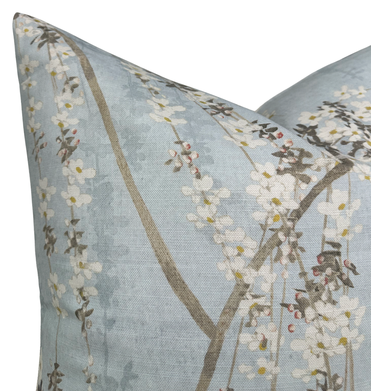 Blue pillow cover with a delicate print of cascading white blossoms and slender brown branches, creating a soft, nature-inspired design.