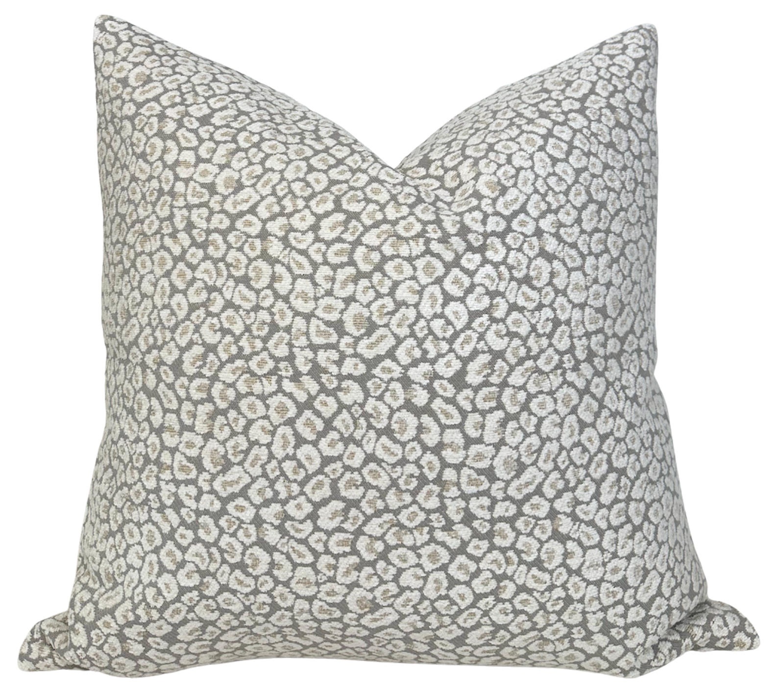 Spotted chenille pillow cover in ivory natural shown on sofa