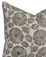 Close-up of a pillow cover with a beige background featuring a detailed sepia-toned floral pattern of large circular flowers and leaves connected by thin stems.
