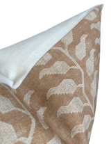 Close-up of a folio pillow cover in ochre with a white abstract leaf pattern and a soft white reverse corner folded over
