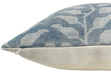 Close-up of a Folio Pillow Cover showing a lake blue textile with light leaf patterns on top and natural beige textured fabric on the bottom, including a visible white zipper.