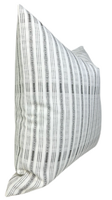 Rectangular pillow cover with vertical charcoal and white stripes, featuring uneven lines and small dot patterns on a light background.