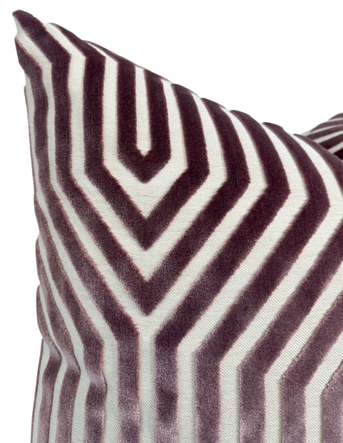 Velvet pillow cover with a geometric pattern of soft lilac and white chevron stripes creating a symmetrical, angular design.