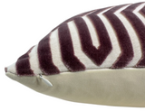 Close-up of a velvet pillow cover showing a lilac and cream zigzag pattern with a visible white zipper on the side seam.
