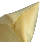 Close-up of a canary yellow velvet pillow cover corner showing smooth, soft texture and subtle sheen on fabric