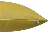 Close-up of a canary yellow velvet pillow cover with a white zipper on one edge, showing smooth textured fabric and clean stitching.