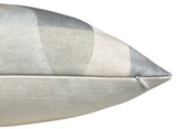 Side view of a Colonnade pillow cover in parchment tones showing subtle geometric pattern and a small white zipper along the edge.